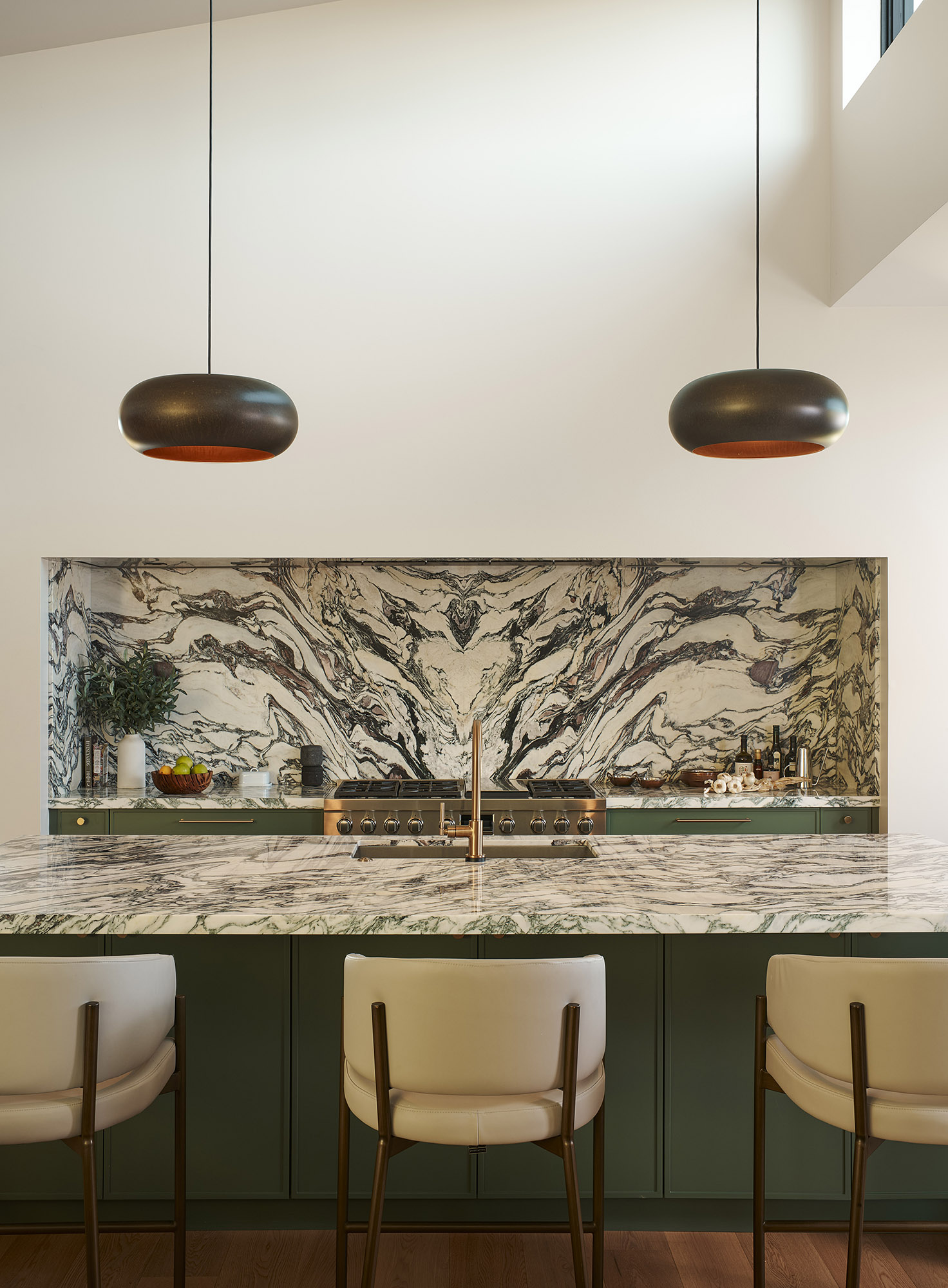 Sonoma wine country kitchen design featuring a Calacatta Monet marble backsplash, island, and green cabinets